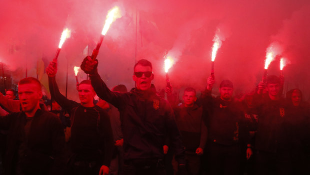 Members of the nationalist movements light flares during a rally marking Defence of the Homeland Day in centre Kiev, Ukraine.