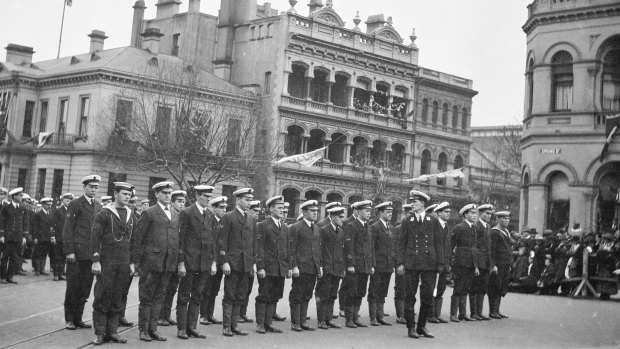 Sailors stand at attention in Spring Street.