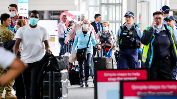 People arriving from overseas were met by police officers at Sydney Airport on Sunday morning. 