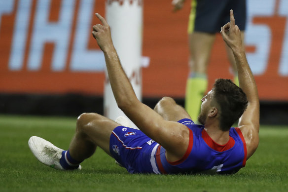 Marcus Bontempelli celebrates after booting a goal in the Bulldogs’ win over Melbourne.