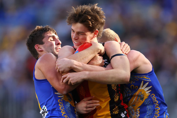 Mattaes Phillipou of the Saints gets tackled by Andrew Gaff and Reuben Ginbey of the Eagles.