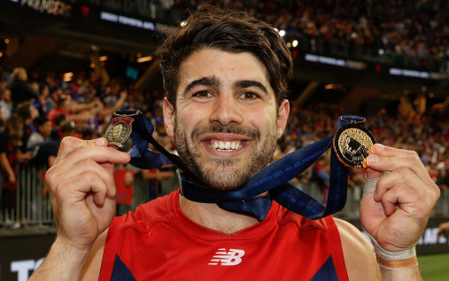 Christian Petracca after the 2021 grand final with his Norm Smith and premiership medals.