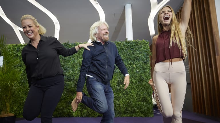 Sir Richard Branson and Sunrise's Samantha Armytage learning yoga from Sjana Elise Earp at the Virgin Lounge at Sydney Airport on Thursday.