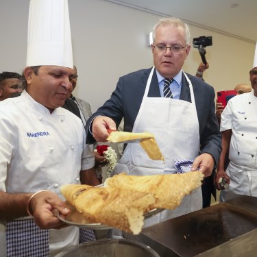 Prime Minister Scott Morrison learns how to cook dosa during a visit to the Shri Shiva Vishnu Temple in Melbourne.