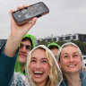 Australian athletes take a selfie on a boat on the Seine.