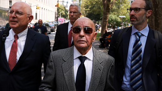 Joe Lewis, centre, leaving court in 2023 after appearing on insider trading charges for which he was convicted.