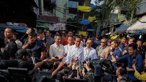 Jokowi, as he is widely known, fronts a local media pack during a visit to Pal Merah traditional market in Jakarta, Indonesia.