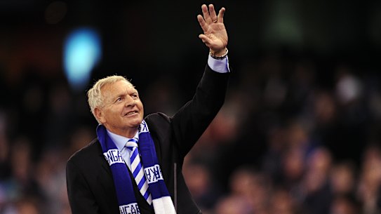 Barry Cable waves to North Melbourne fans at a game in 2012.