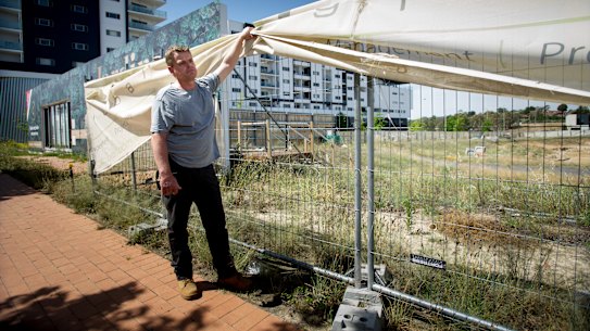 Andrew Bennett, at the site of an apartment building for which he paid a deposit almost two years ago but has now had the contract scrapped.