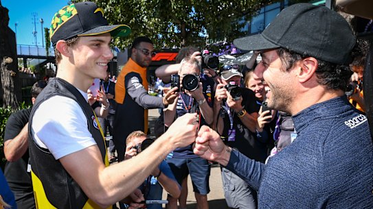 Oscar Piastri and Daniel Ricciardo say g’day in front of the media pack.