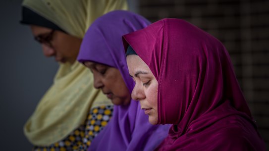 Muslim women Mai Shouman, Meherun Nisa and
Rita Joyan pray at Gungahlin Mosque on Saturday afternoon, after terror attacks at mosques in New Zealand on Friday.