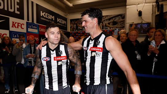 Jamie Elliott and Scott Pendlebury in the rooms post-game.