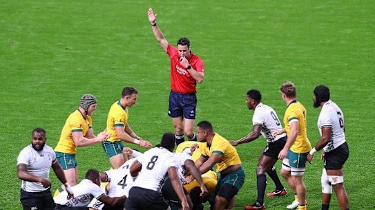 Referee Ben O'Keeffe awards a penalty to Australia.