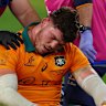 Carlo Tizzano of the Wallabies receives medical attention after the clash with Jac Morgan.