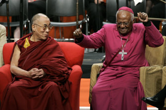The Dalai Lama, left, looks on as Archbishop Desmond Tutu does an impromptu dance move after remarking that his wireless microphone made him feel like pop star Michael Jackson, during an event at the University of Washington in Seattle in 2008. 