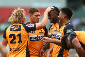 Joe Powell is congratulated by teammates after a try against the Sunwolves.