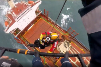 A rescue chopper attempts to reach crew on the Portland Bay cargo ship stranded off Royal National Park.
