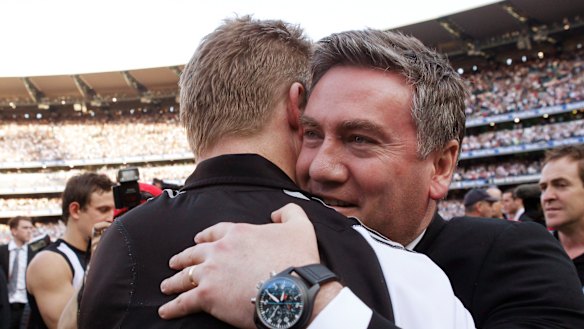 Eddie McGuire embraces then assistant coach Nathan Buckley after Collingwood win the 2010 flag.