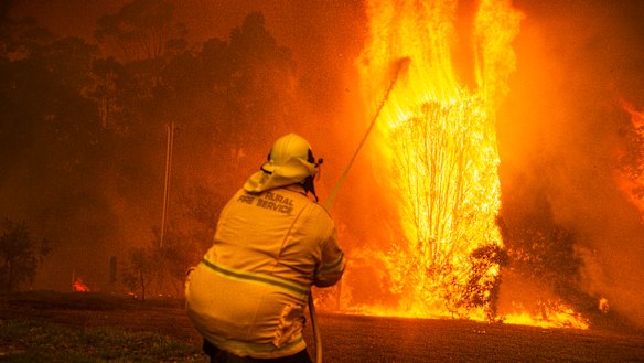 Wreck Bay fire crew protect a property on Jindelara Creek Road from the Currowan fire in the state's south.