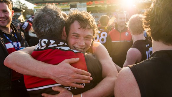 Joshua Taylor hugs Coach Chris Rourke after winning the grand final.