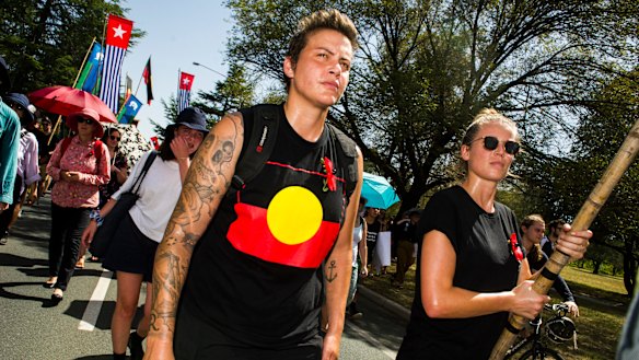 Invasion Day protesters march through Canberra on their way to the Aboriginal Tent Embassy on Saturday morning.