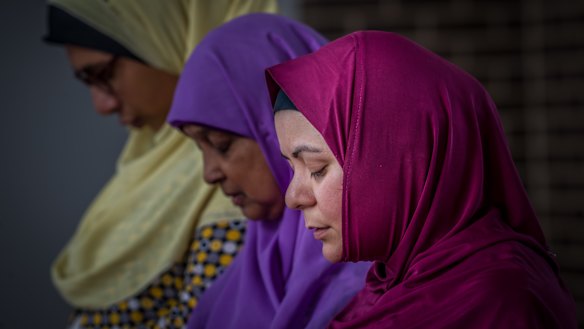 Muslim women Mai Shouman, Meherun Nisa and
Rita Joyan pray at Gungahlin Mosque on Saturday afternoon, after terror attacks at mosques in New Zealand on Friday.