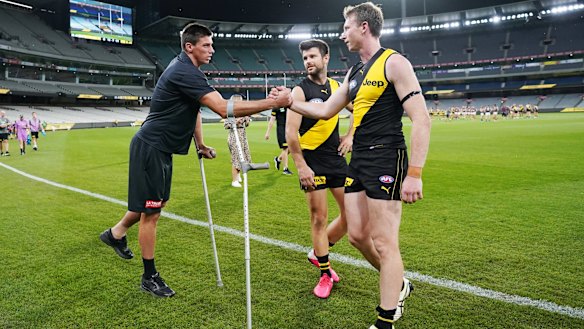 Get well soon: Tigers Dylan Grimes and Trent Cotchin (right) console injured Blue Matthew Kreuzer.