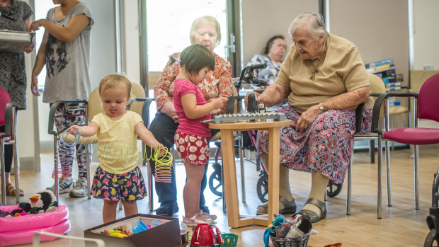 Judy Baker  plays with Lily Rossiter,3, while Gemma Woods, 22 months, (left) plays. 