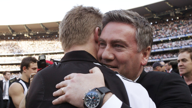 Eddie McGuire embraces then assistant coach Nathan Buckley after Collingwood win the 2010 flag.