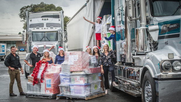 Helpers load the Christmas packages for transport from  Canberra to regional NSW.