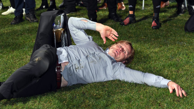 Busting a move: Crusaders coach Scott Robertson break-dances in front of the Super Rugby trophy.