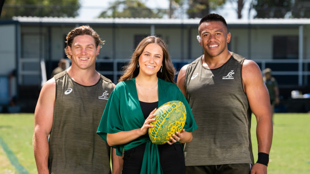 Wallabies captain Michael Hooper and prop Allan Alaalatoa with Indigenous schoolgirl Olivia Fox. 