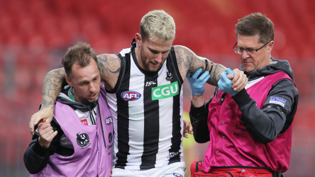 Jeremy Howe is aided off the field with a knee injury during round four. 