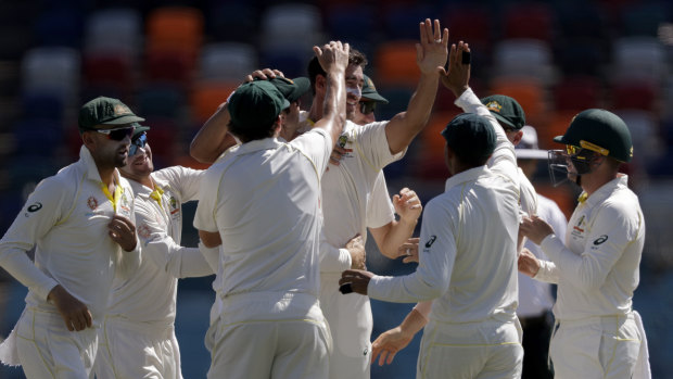 Mitchell Starc is congratulated after one of his breakthroughs this morning.