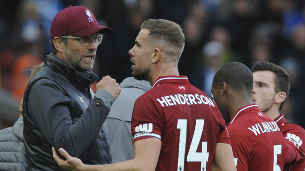 Jurgen Klopp, left, has compared Liverpool's shock loss to a punch in the face. 
