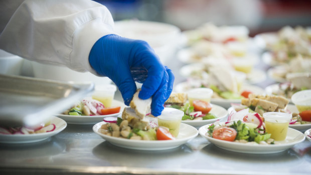 A business class meal is finished off in the cold kitchen (salad with chicken, cherry tomatoes, Cannellini beans and dill vinaigrette). 