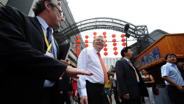 Former colleagues: then ambassador Geoff Raby (left) takes then prime minister Kevin Rudd (centre) on a tour of central Beijing in 2008.