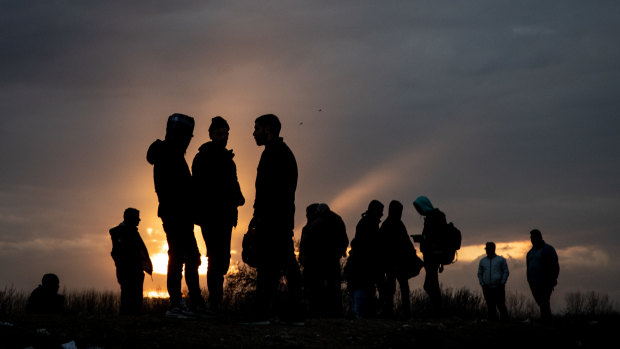 Refugees and migrants are seen at a makeshift camp next to the Edirne Old Bridge in Turkey. Thousands of refugees and migrants have flocked to the border after Turkey made good on a promise to stop blocking their passage to Europe.