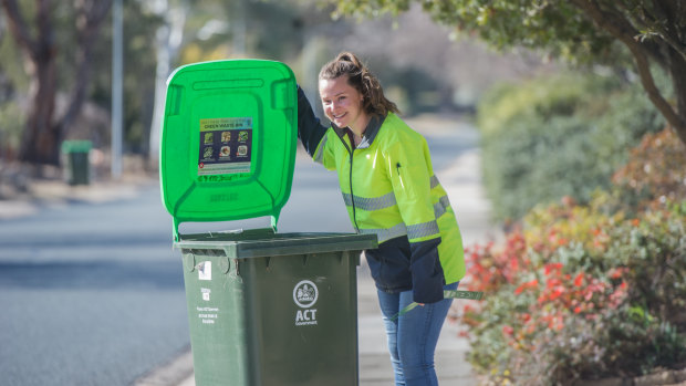 Envirocom environment education officer Kathryn Sullivan inspecting green waste bins in Kambah. Green waste bins are being randomly inspected to see who is or who isn't doing the right thing .
