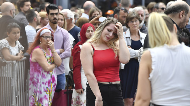 Members of the public attend a moment of silence for the shooting victims near the City Hall in Liege.
