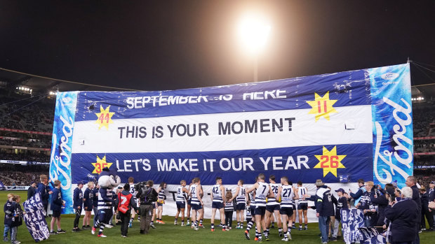 Time to shine: Geelong players walk to the banner before taking on Collingwood in the first qualifying final.