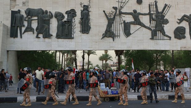 Iraqi security forces close Tahrir Square while protesters gather demanding services and jobs in central Baghdad, on  Saturday, July 14.