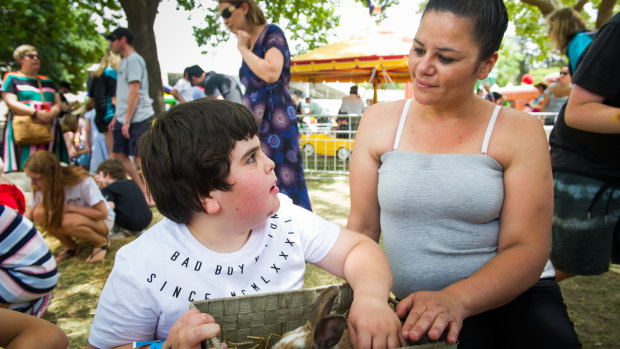 Murrah Bond, 8, with mum Alinta Parsons enjoying the petting zoo at the Special Children's Christmas Party.