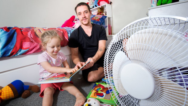 Jay, with his daughter Hayley, 3, in her bedroom, which has the only fan in the house. 