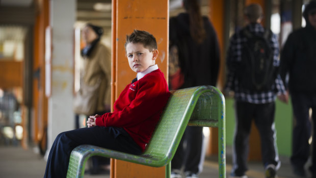 Elijah Sham, 7, will have to get on a public bus and make multiple connections to get to school from the Woden bus interchange