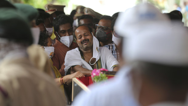 B. Upender weeps by the coffin of his son, Colonel B. Santosh Babu in Suryapet, about 140 kilometres from Hyderabad, India. Babu was among the 20 Indian troops who were killed in the clash.