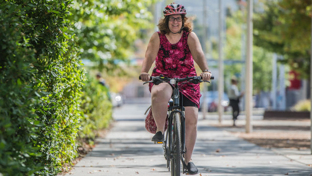 Elizabeth Zatschler rides her bike in central Canberra, near her office.