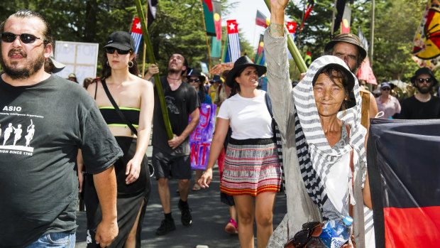 Invasion Day protesters march through Canberra on their way to the Aboriginal Tent Embassy on Saturday morning.