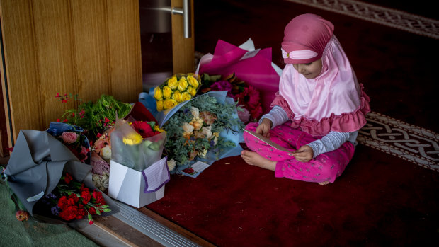 Alishiba Jadoon, 4 checks out the flowers and well wishes left by the Canberra community in support of their Muslim neighbours. 