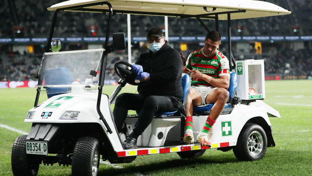 The Souths centre is carted off after dislocating his right kneecap against the Bulldogs last July.